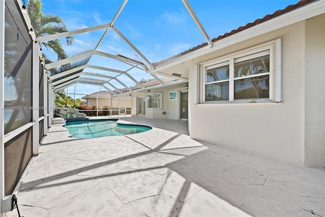 view of swimming pool featuring a patio and a lanai