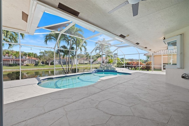 view of swimming pool with glass enclosure, a water view, and a patio