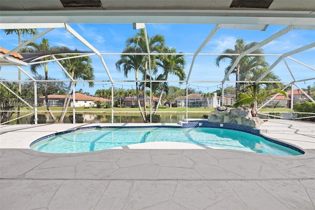 view of pool featuring a water view, glass enclosure, and a patio area