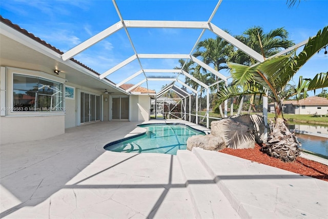 view of swimming pool with a patio area and a lanai