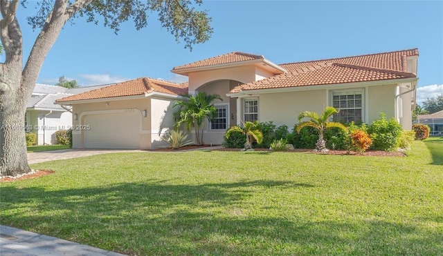 mediterranean / spanish-style home with a garage and a front lawn