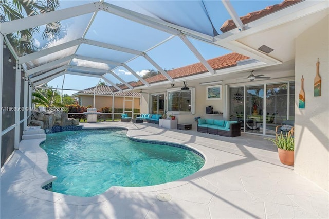 view of swimming pool featuring an outdoor living space, ceiling fan, a lanai, and a patio