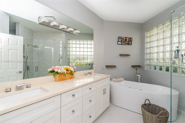 bathroom featuring plus walk in shower, vanity, and tile patterned floors