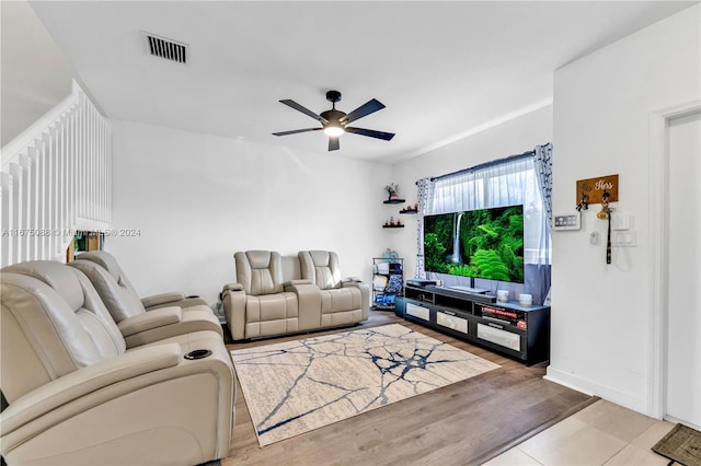 living room featuring ceiling fan and light hardwood / wood-style flooring