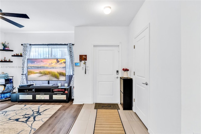 foyer featuring wood-type flooring and ceiling fan