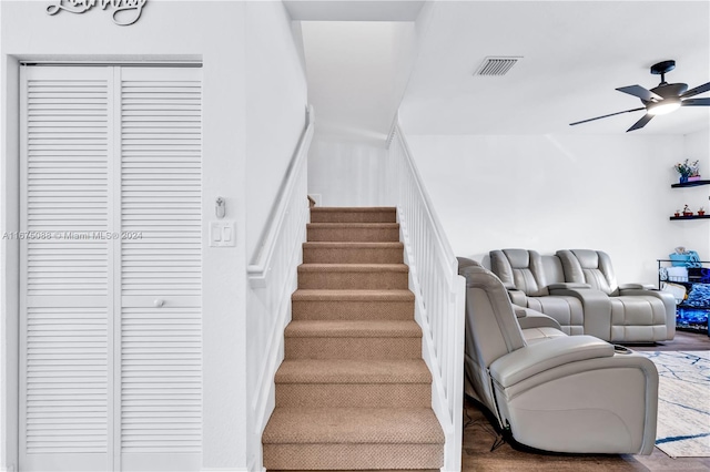 stairway featuring wood-type flooring and ceiling fan