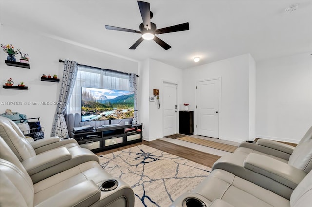 living room featuring ceiling fan and hardwood / wood-style flooring