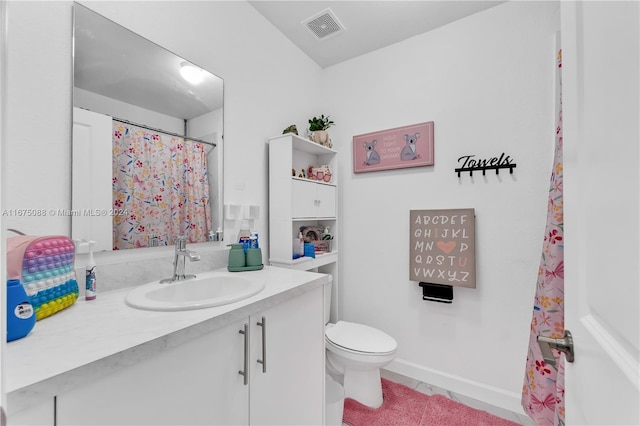 bathroom featuring vanity, toilet, and tile patterned flooring