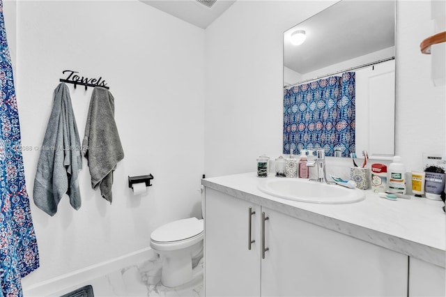 bathroom with vanity and toilet