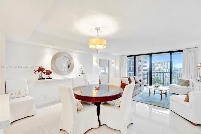 dining room featuring light tile patterned flooring and a wall of windows