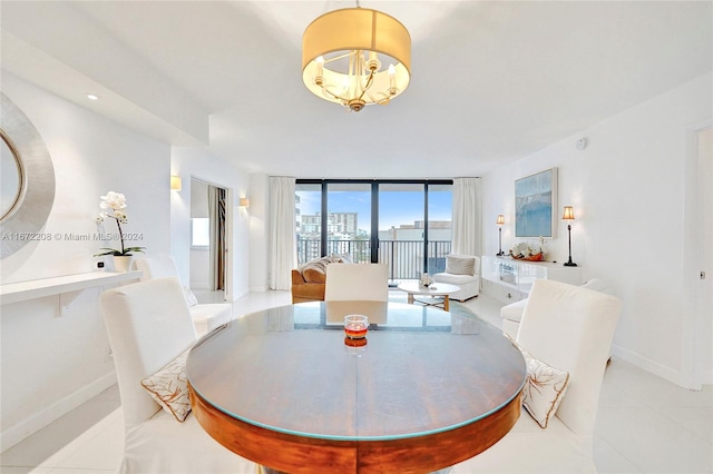 tiled dining area with a wall of windows and a notable chandelier