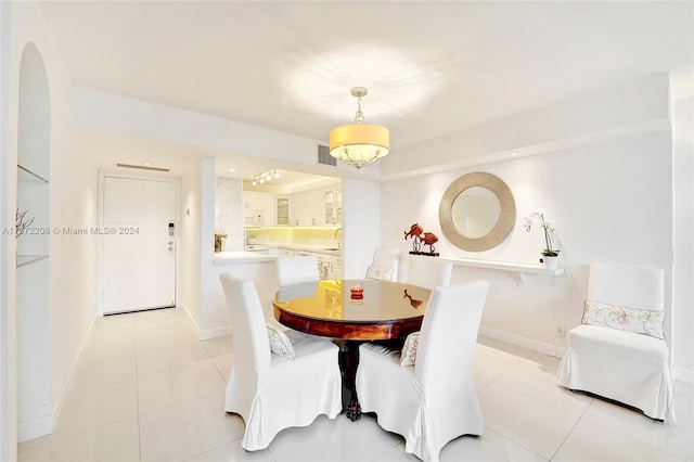 dining area featuring light tile patterned flooring and sink