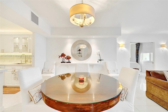 dining space with a chandelier and sink