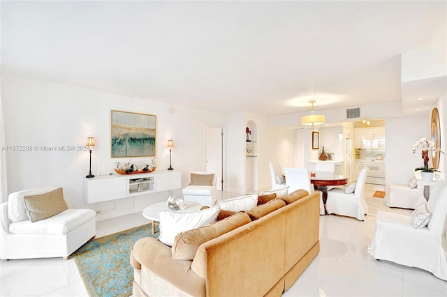 living room with light tile patterned floors and washer / dryer