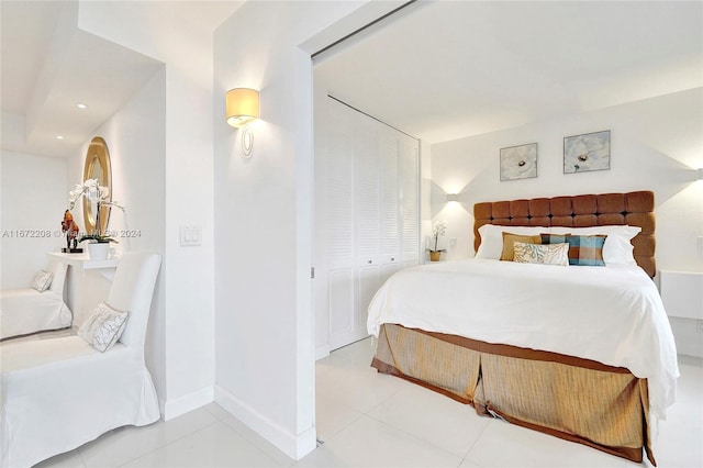 bedroom with light tile patterned flooring and a closet