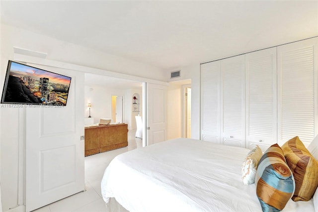 bedroom featuring light tile patterned flooring and a closet