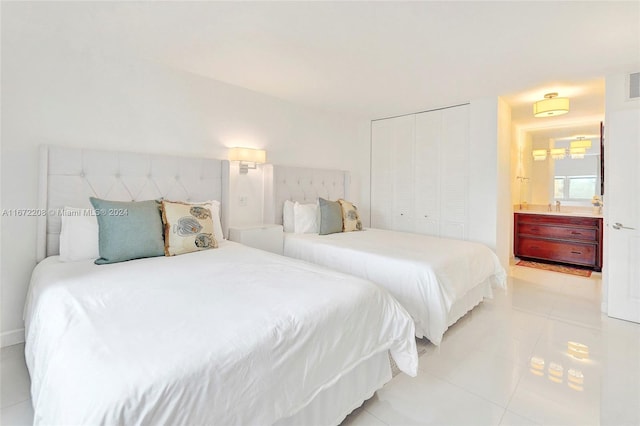 tiled bedroom featuring a closet