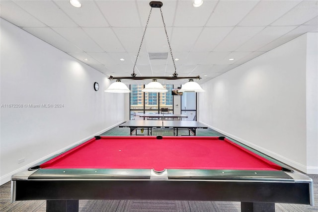 recreation room featuring a paneled ceiling and carpet flooring