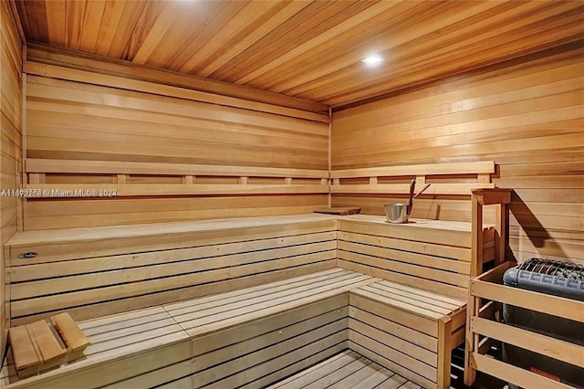 view of sauna / steam room featuring wood walls and wooden ceiling