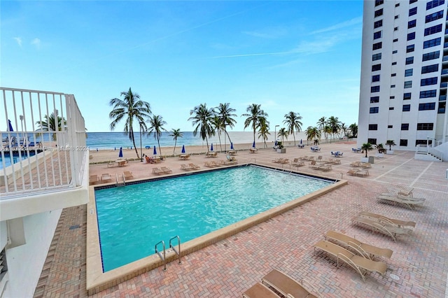 view of pool with a water view