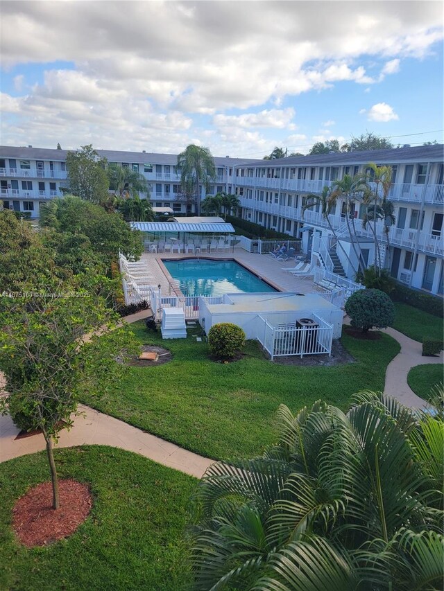 view of pool with a yard