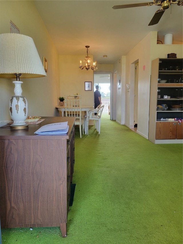 interior space with ceiling fan with notable chandelier and carpet