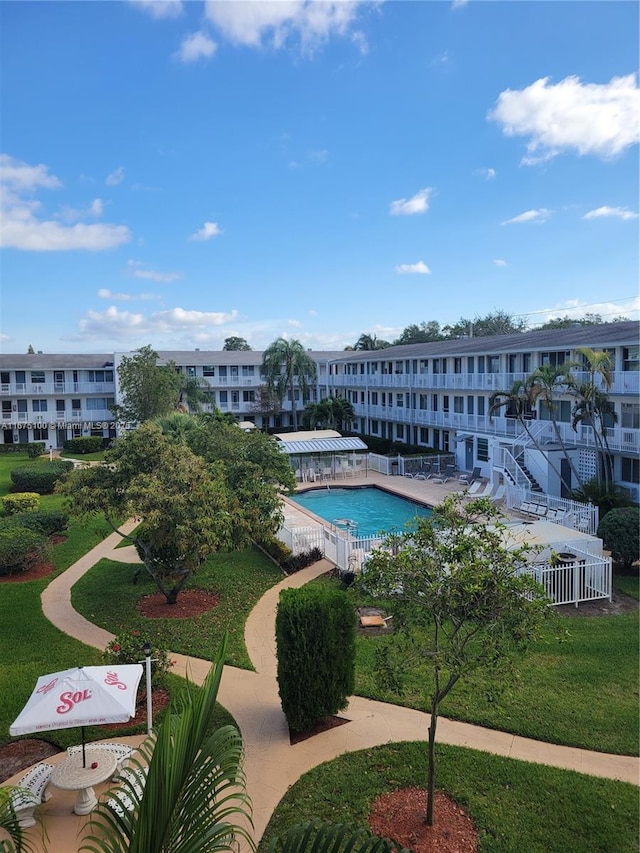 view of swimming pool featuring a yard and a patio area