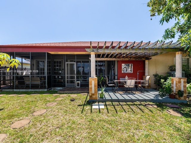 232 SW 7th Ave, Hallandale Beach, FL 33009 - back of house featuring a lawn, a patio, a sunroom, and a pergola