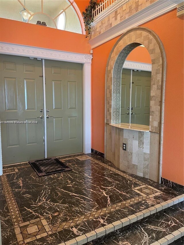 foyer featuring a towering ceiling