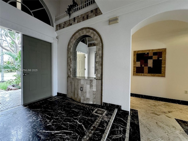 232 SW 7th Ave, Hallandale Beach, FL 33009 - entrance foyer featuring baseboards, arched walkways, and marble finish flooring