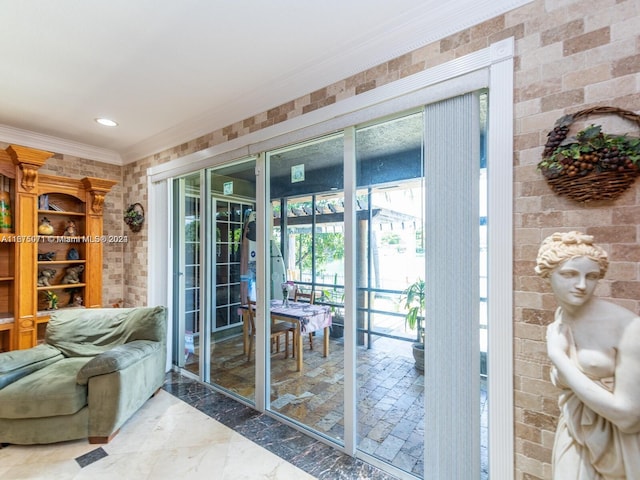 doorway featuring brick wall and crown molding