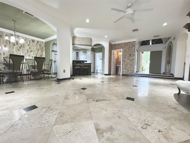 232 SW 7th Ave, Hallandale Beach, FL 33009 - living area featuring ornamental molding, arched walkways, ceiling fan, baseboards, and stone tile floors