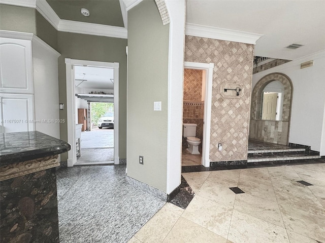 232 SW 7th Ave, Hallandale Beach, FL 33009 - bathroom with ornamental molding, toilet, baseboards, and tile walls
