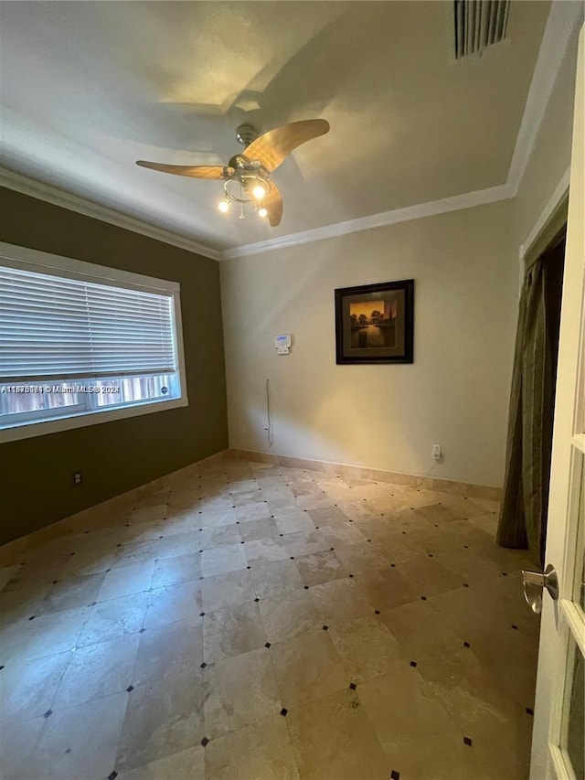 empty room with ornamental molding and ceiling fan