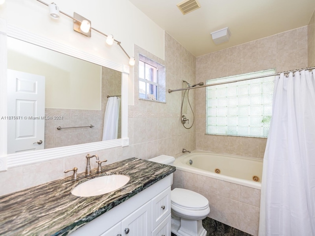 full bathroom with toilet, shower / bath combo, plenty of natural light, and vanity