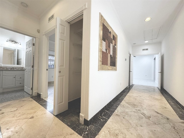 232 SW 7th Ave, Hallandale Beach, FL 33009 - hall with attic access, baseboards, a sink, stone tile floors, and recessed lighting