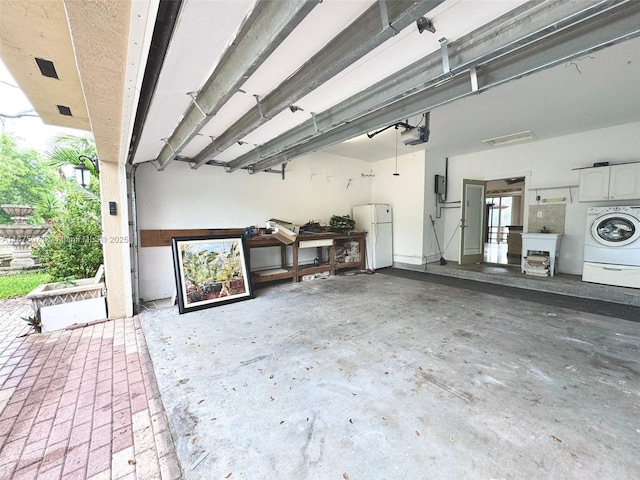 232 SW 7th Ave, Hallandale Beach, FL 33009 - garage featuring washer / dryer, a garage door opener, freestanding refrigerator, and french doors