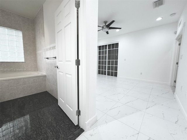 232 SW 7th Ave, Hallandale Beach, FL 33009 - bathroom featuring ceiling fan, a garden tub, marble look tiles, recessed lighting, and baseboards