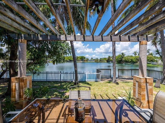 view of patio / terrace with a pergola and a water view