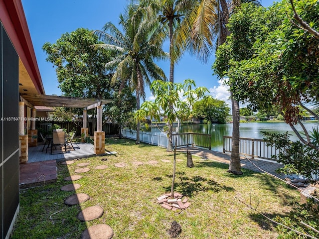 view of yard with a patio, a pergola, and a water view