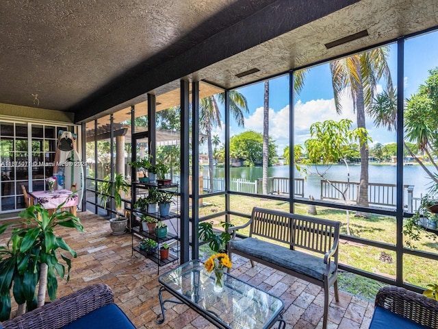 unfurnished sunroom featuring a water view and a healthy amount of sunlight