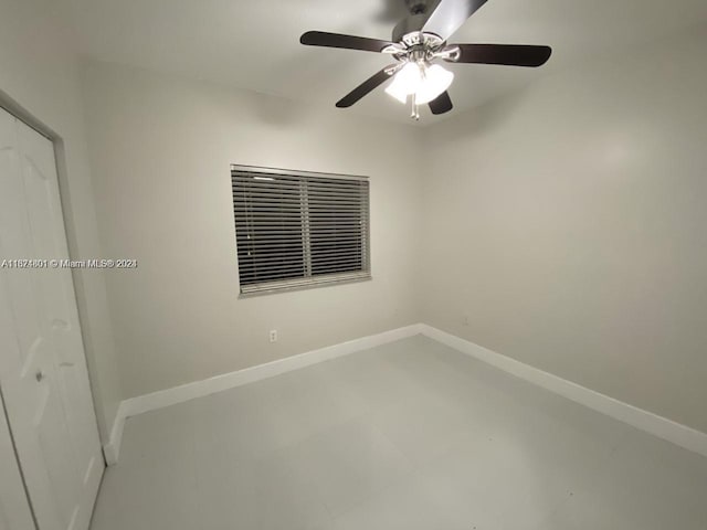 spare room featuring concrete flooring and ceiling fan