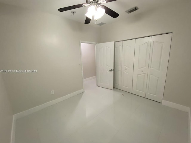 unfurnished bedroom featuring ceiling fan, a closet, and light tile patterned floors