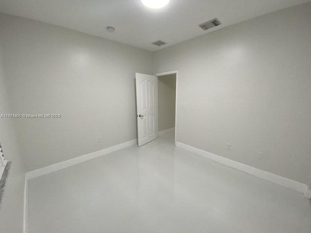 unfurnished room featuring concrete flooring