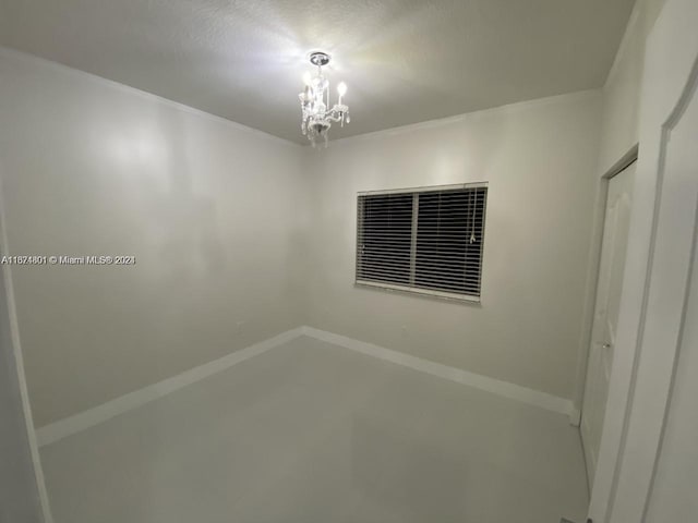 empty room featuring a notable chandelier