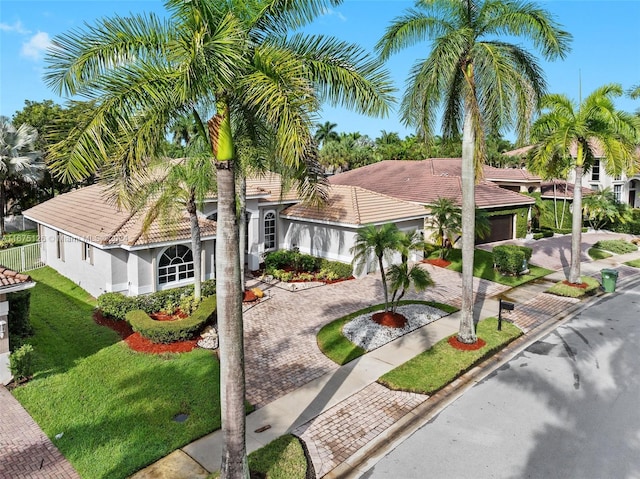 mediterranean / spanish house with a front yard and a garage