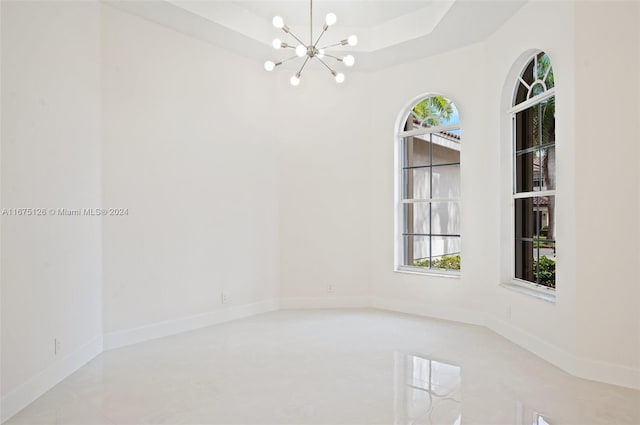 unfurnished room featuring a notable chandelier