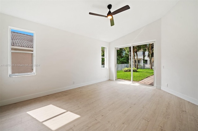 spare room featuring light wood-type flooring, ceiling fan, and vaulted ceiling