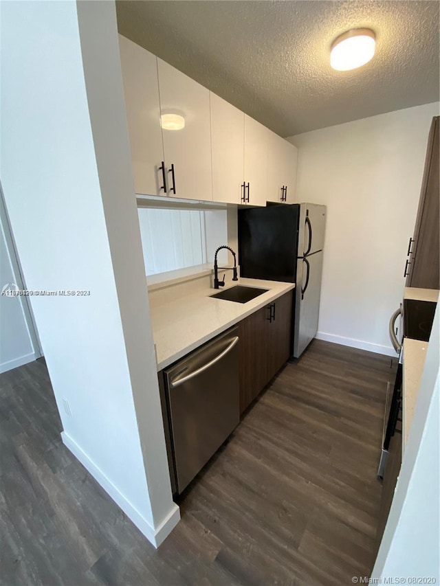 kitchen with white cabinets, sink, stainless steel dishwasher, a textured ceiling, and dark hardwood / wood-style flooring