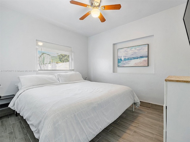 bedroom with hardwood / wood-style floors and ceiling fan